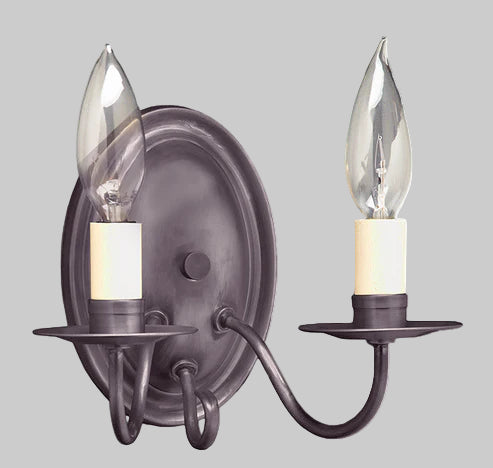 Wall-mounted candle-style light fixture with two glass candle covers on a gray background