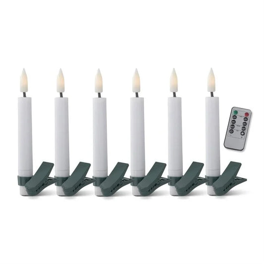 A set of six white LED tree clip candles with green clips and a remote control.