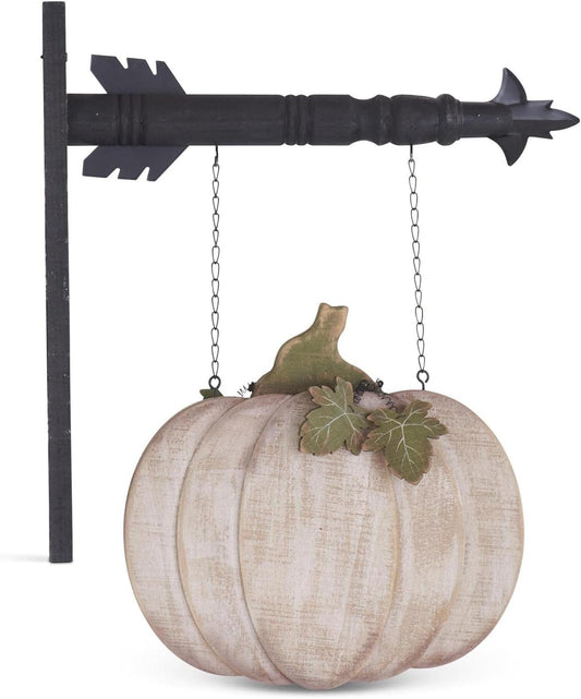 A whitewashed wood pumpkin with a brown stem and green leaves, hanging from a black arrow replacement part.