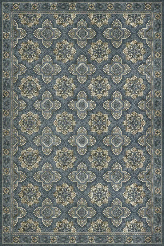 A Colonial reproduction floor cloth featuring a geometric pattern in a blue color.