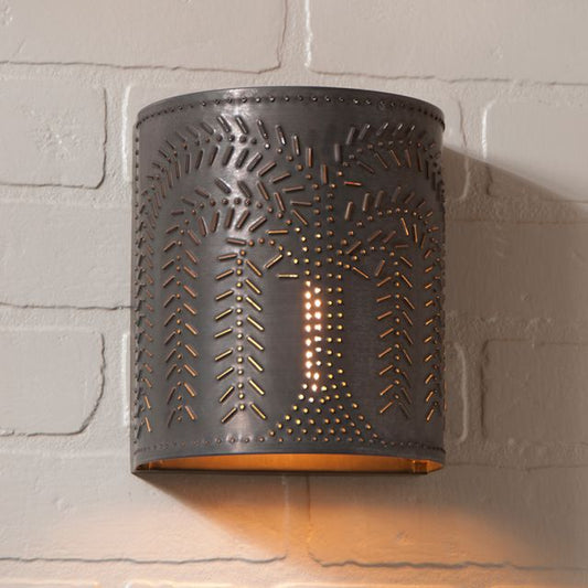 Tin sconce with open bottom and willow tree design on brick background
