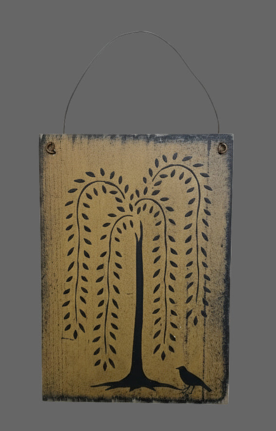 Wooden wall hanging with tree design on a grey background