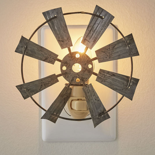 A night light that resembles a windmill plugged into a wall outlet