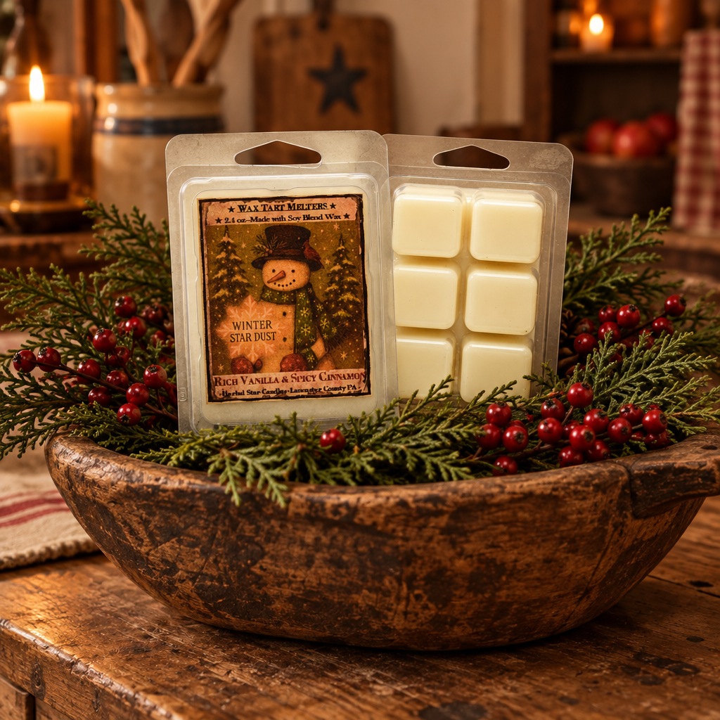 Two wax melt packages displayed in a rustic wooden bowl filled with greenery and red berries, with warm candles and a cozy indoor background.