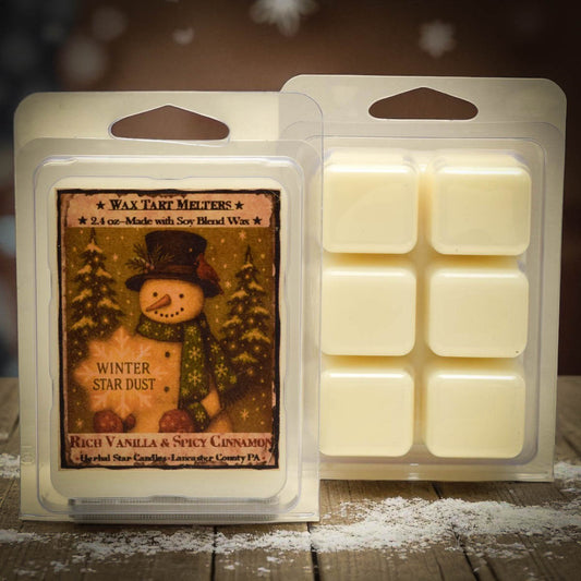 Wax tart melt package with snowman design and vanilla cinnamon scent on a wooden surface.
