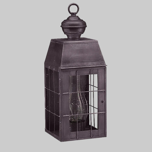 Decorative metal lantern with glass panels on a white background