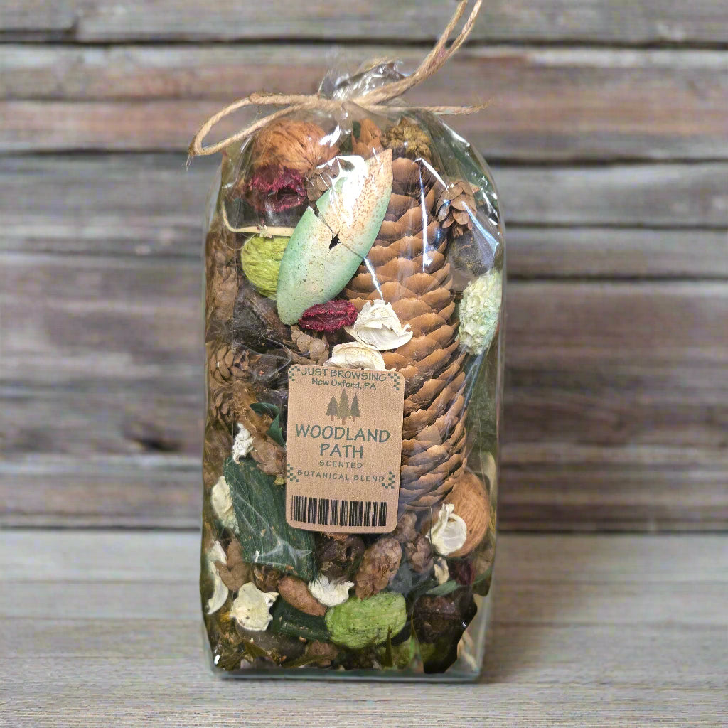 Decorative jar with natural elements on a green leafy background