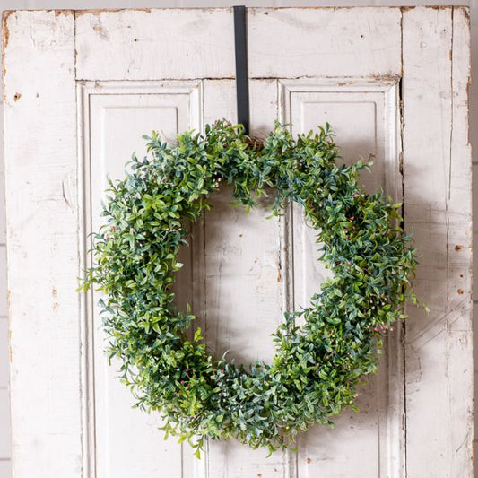 Primitive wreath hook holding a wreath on a white door