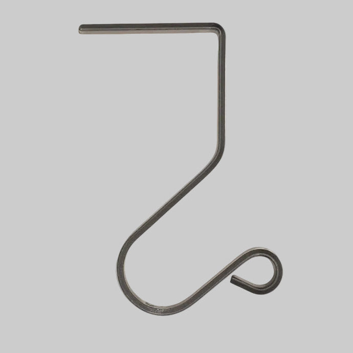 Dark wrought iron mantle hook with a flat top arm and curved scroll end against a light gray background.