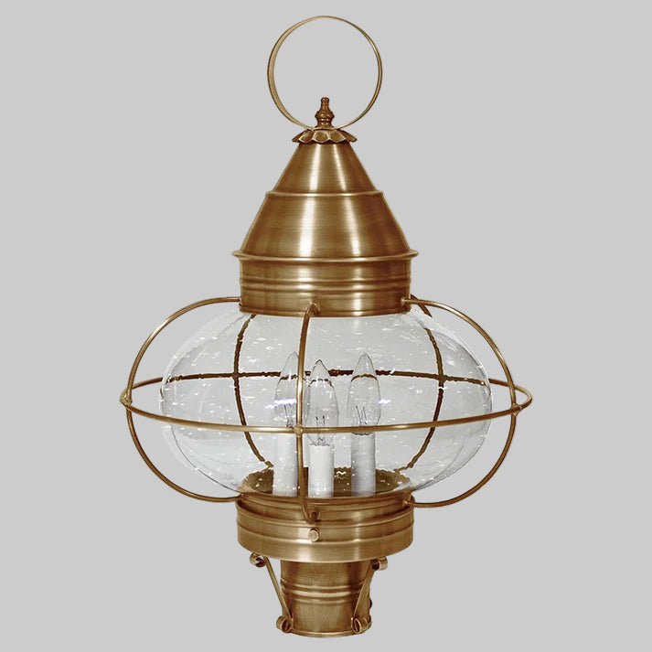 Brass outdoor lantern with clear glass shade on a white background