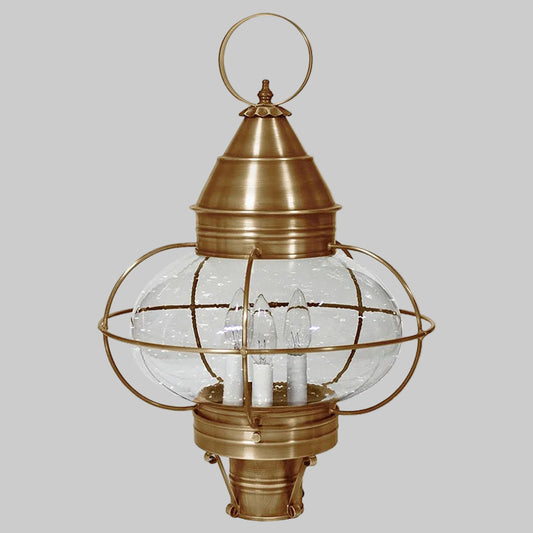 Brass outdoor lantern with clear glass shade on a white background