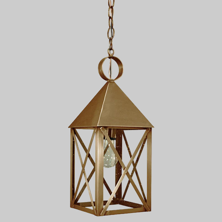 Gold hanging lantern with a clear bulb on a gray background