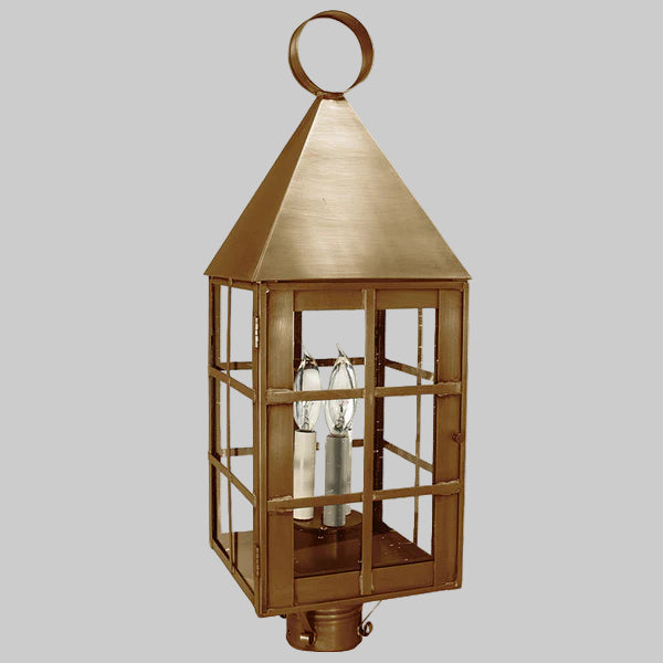 Decorative brass outdoor lantern on a gray background
