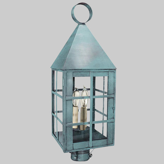 Decorative outdoor lantern with a metallic finish on a white background