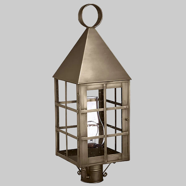 Bronze lantern with glass panels on a gray background
