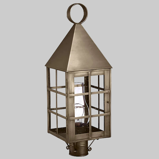 Bronze lantern with glass panels on a gray background