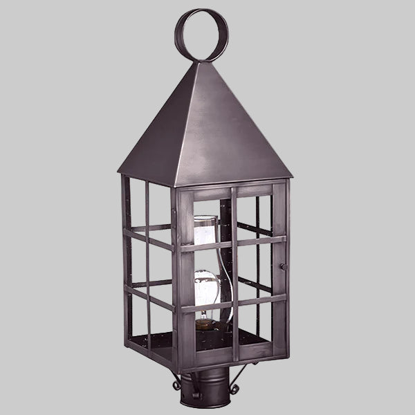 Decorative outdoor lantern with a metallic finish on a gray background