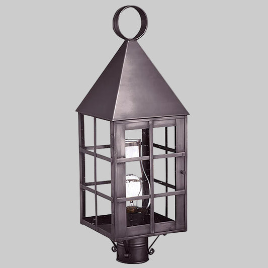 Decorative outdoor lantern with a metallic finish on a gray background