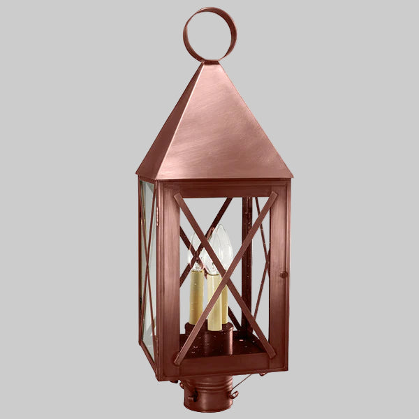 Copper outdoor lantern with clear glass on a gray background