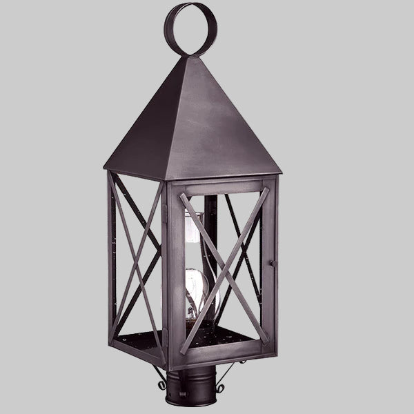 Decorative outdoor lantern with a metallic finish on a gray background