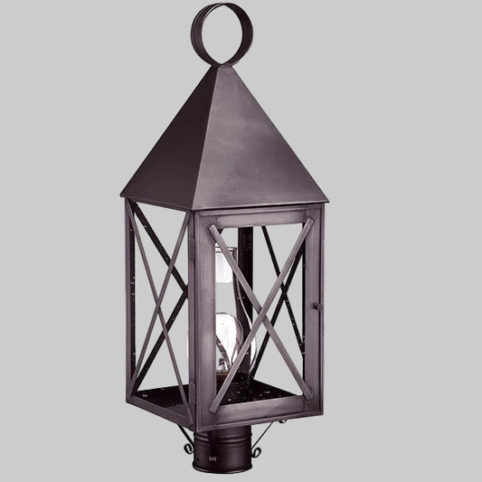 Decorative outdoor lantern with a metallic finish on a gray background