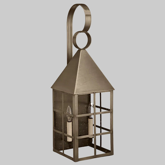 Bronze lantern with a decorative top on a light gray background