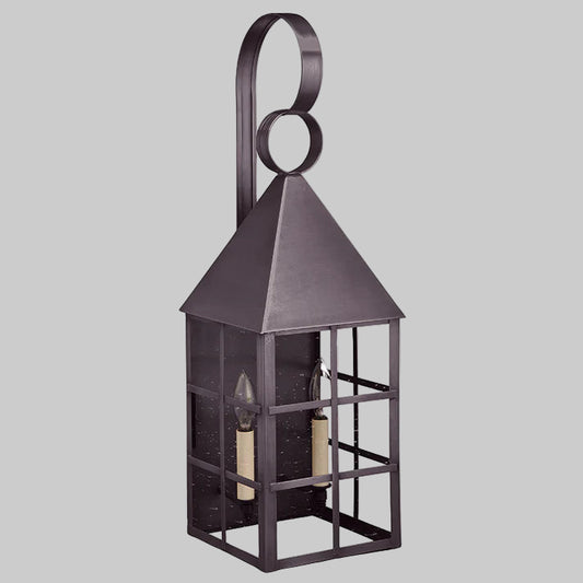 Decorative metal lantern with a white candle inside on a white background