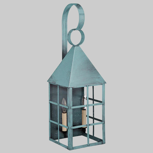 Decorative verdi gris wall lantern with a handle on a white background