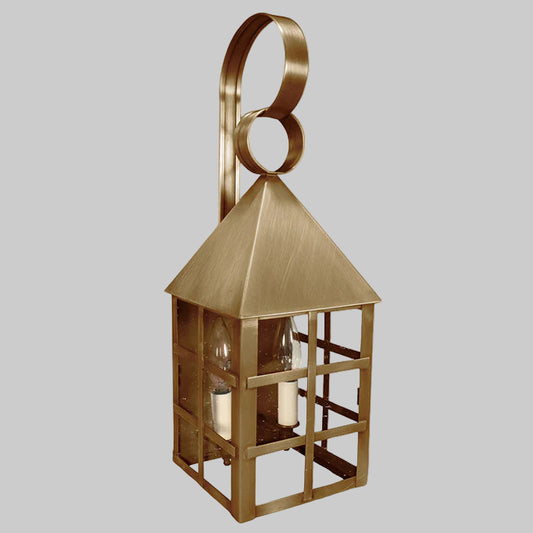 Brass wall lantern with a decorative ring on a gray background
