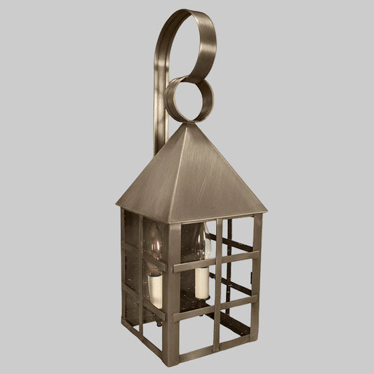 Bronze outdoor wall lantern with a decorative ring on a gray background