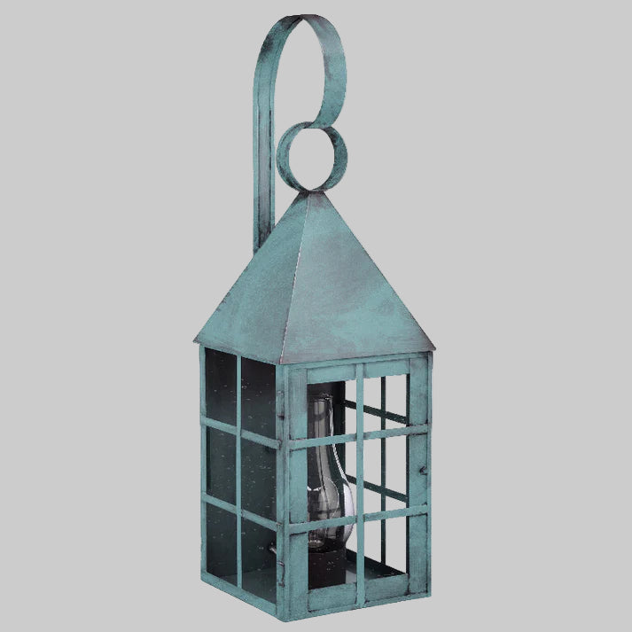 Decorative verdi gris lantern with a handle on a light gray background