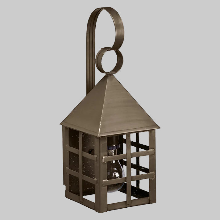 Bronze-colored lantern with a geometric design on a gray background