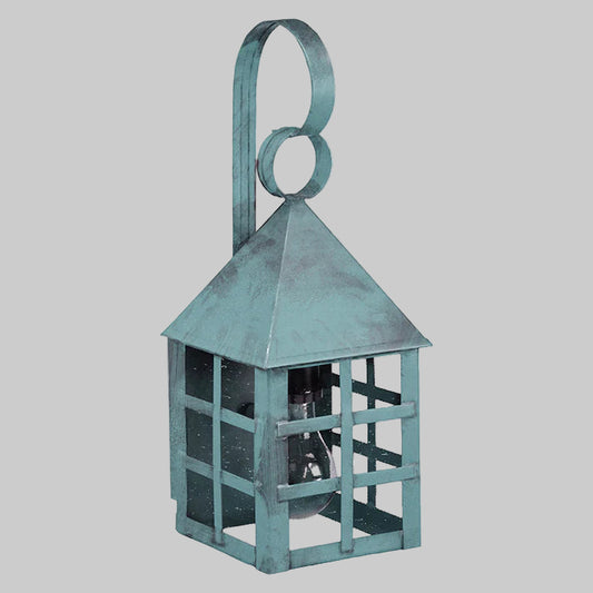 Teal metal lantern with a decorative handle on a gray background