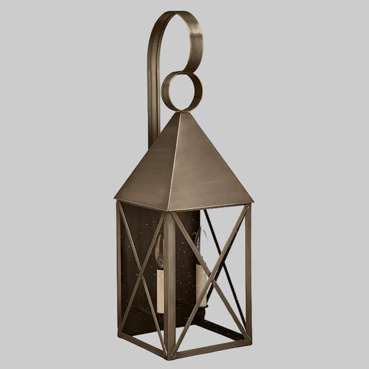 Bronze lantern with geometric design on a gray background