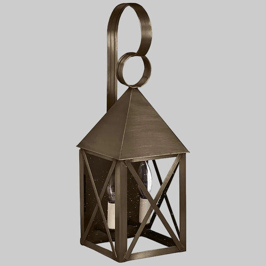 Bronze lantern with geometric design on a gray background