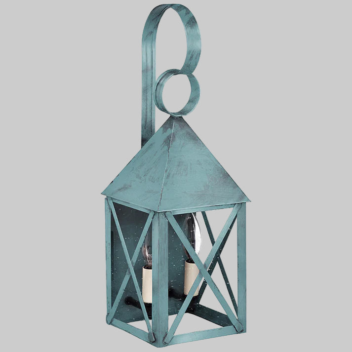 Teal metal lantern with a candle inside on a gray background