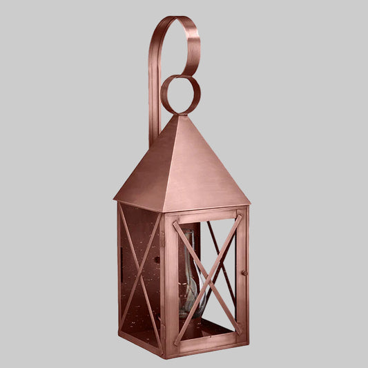 Copper lantern with geometric design on a gray background