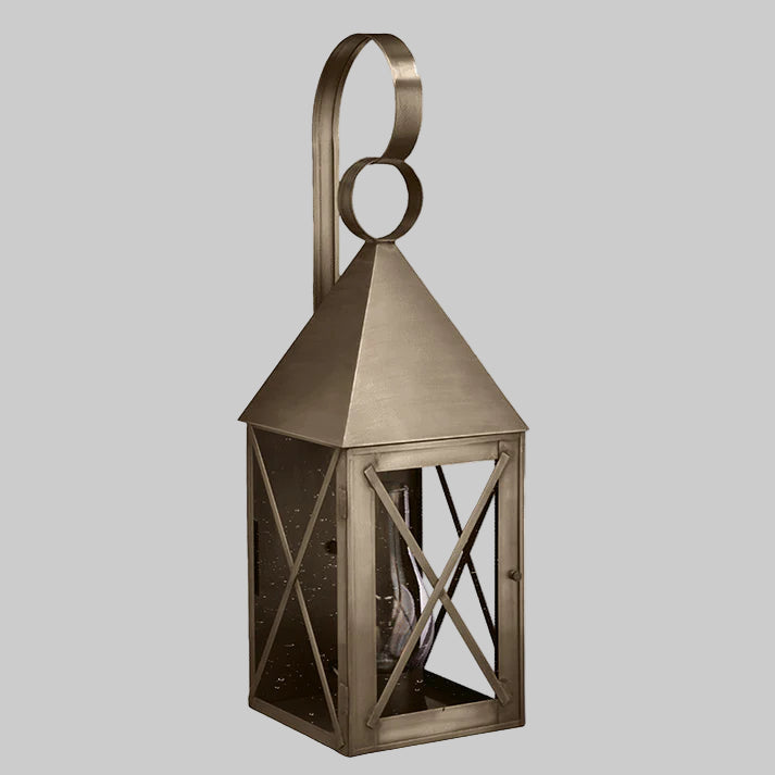 Bronze lantern with geometric design on a gray background