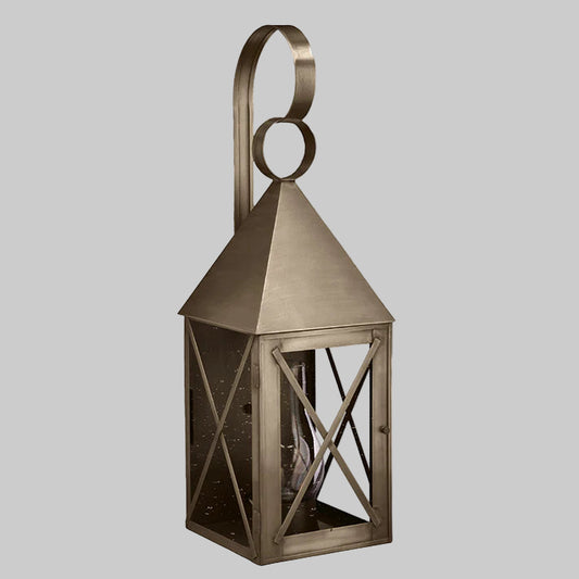 Bronze lantern with geometric design on a gray background