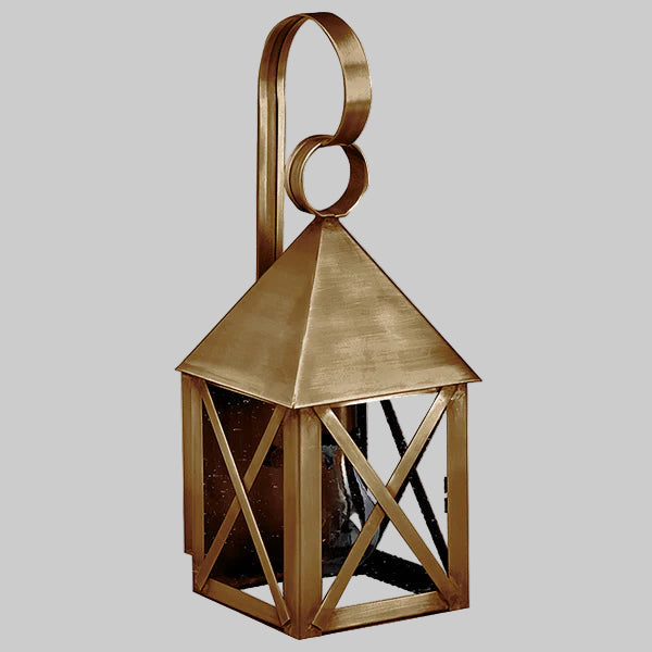 Bronze lantern with geometric design on a gray background