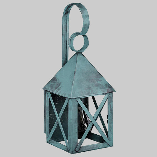 Decorative metal lantern with a greenish-blue patina on a gray background